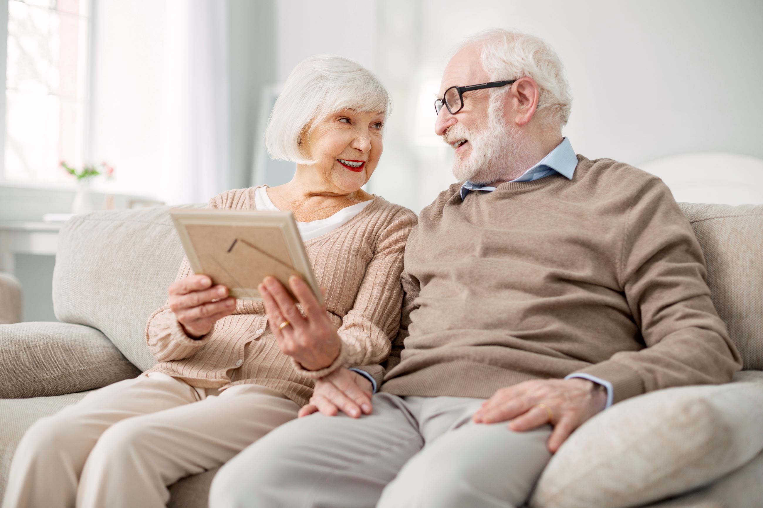 Couple sitting on couch together. 