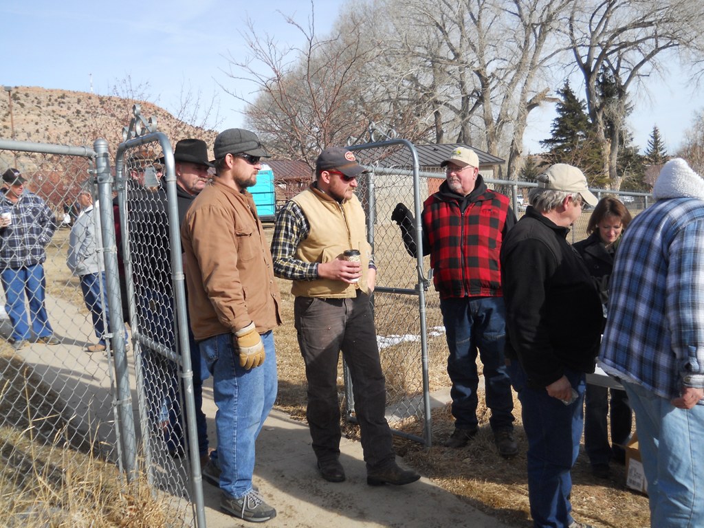 Photo of people entering the rodeo arena and grabbing a ticket for the drawings during the closing ceremonies of the 2012 Burbot Bash