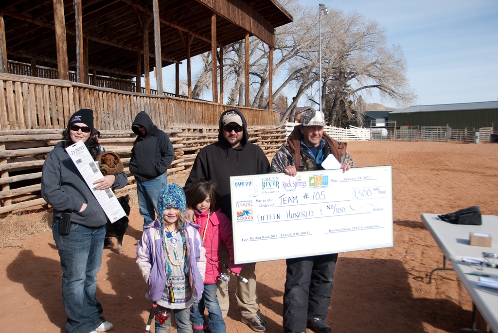 Photo of the winners of the tagged fish drawing accept their check at closing ceremonies of the 2012 Burbot Bash