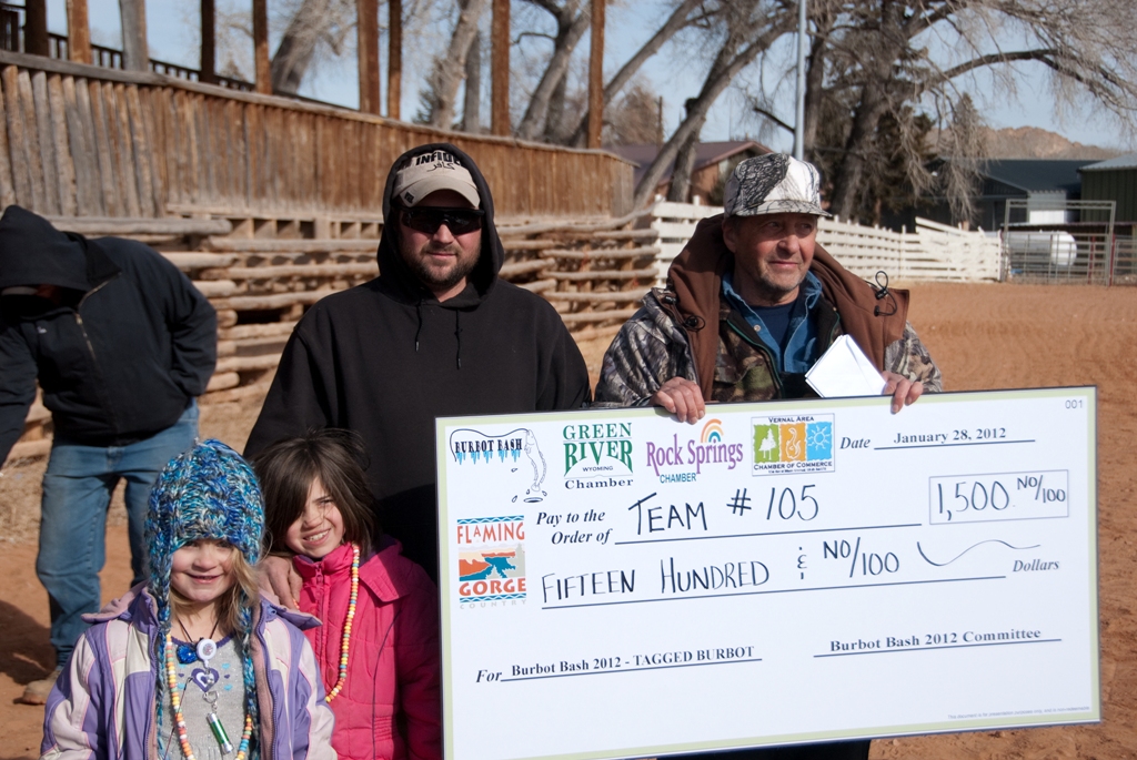 Photo of the winners of the tagged fish drawing accept their check at closing ceremonies of the 2012 Burbot Bash