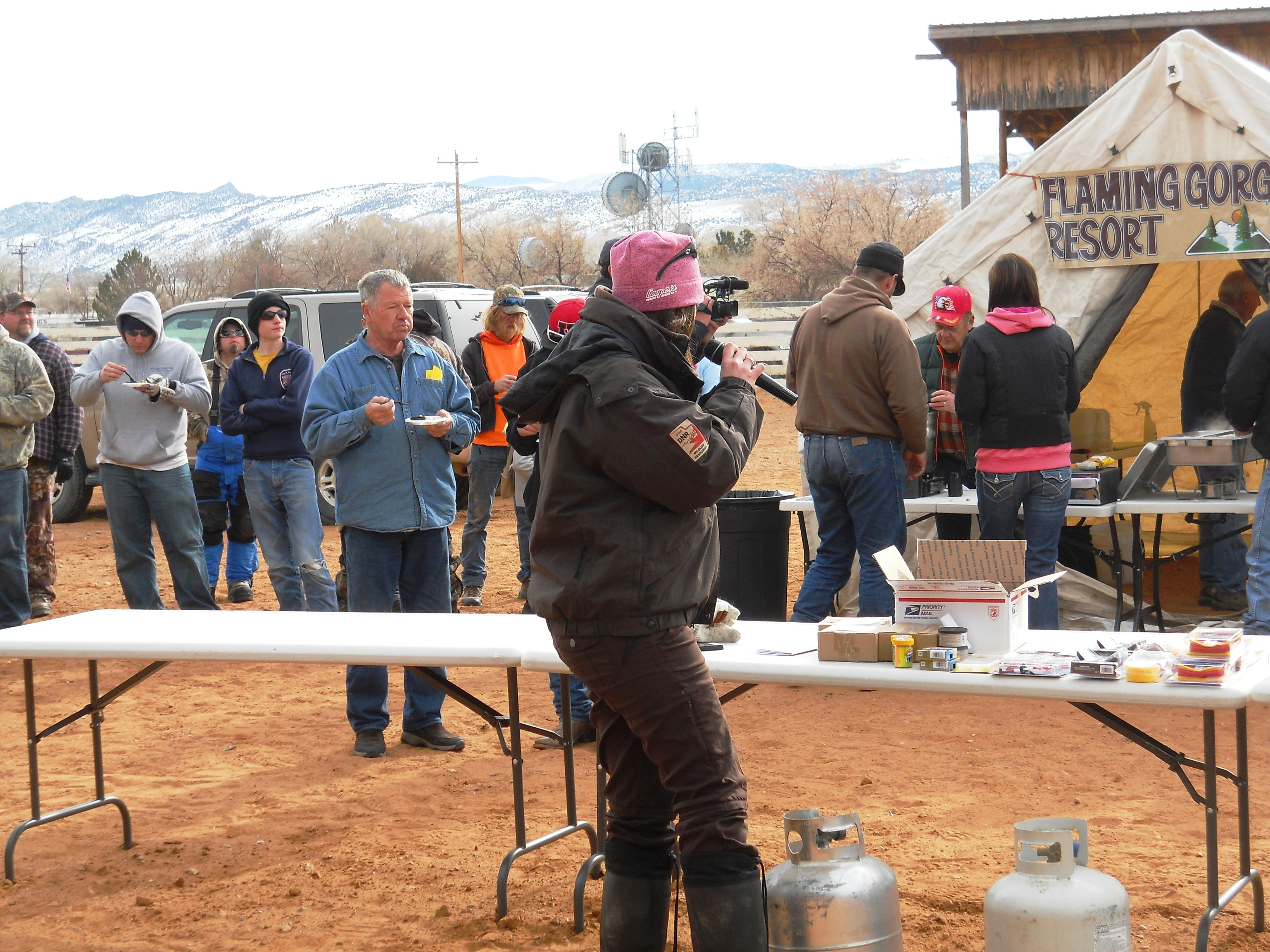 Photo of Tonya Kieffer of KSL's Utah Outdoors makes announcements while Burbot Bash participants enjoy burbot prepared by the Flaming Gorge Resort.