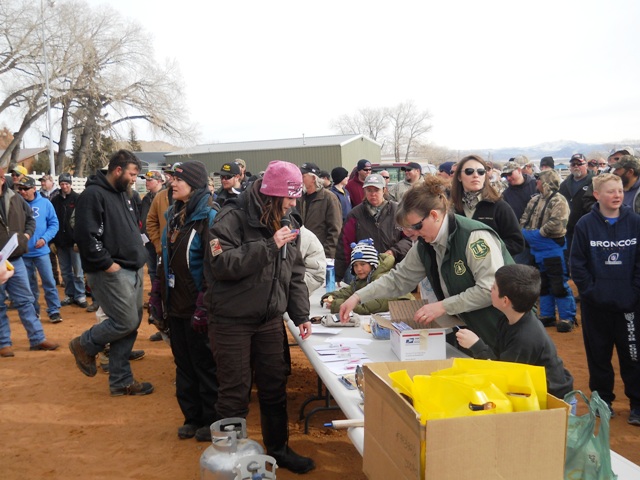 Tonya of KSL Outdoor Utah  announces prize winners in the drawing during the Closing Ceremonies of the 2013 Burbot Bash while Forest Service staff and Chamber volunteers help distribute the prizes. 