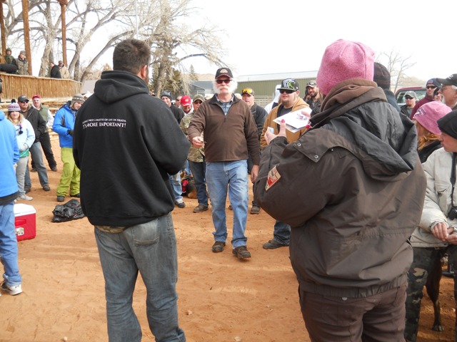 Photo of a prize winner coming forward to claim his prize during the Closing Ceremonies of the 2013 Burbot Bash.
