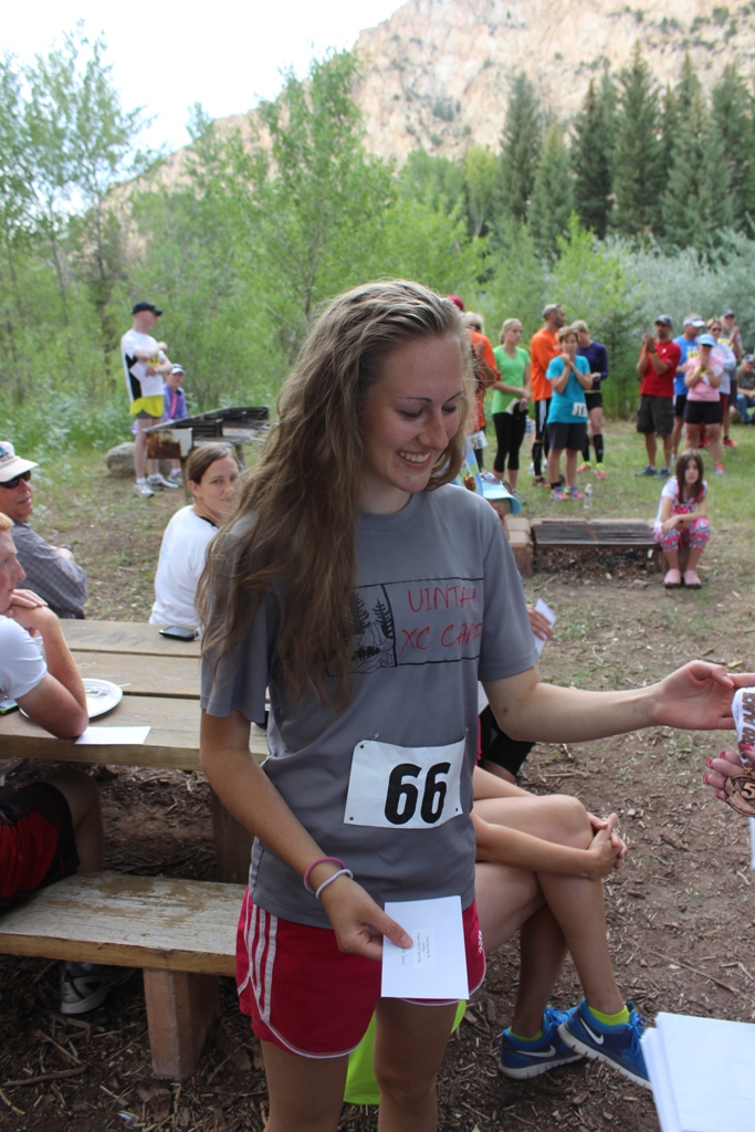 Photo of an age group winner receiving her award for the Tower Rock Run 5k 