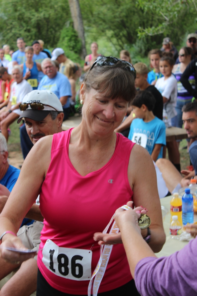 Photo of an age group winner receiving her award for the Tower Rock Run 5k