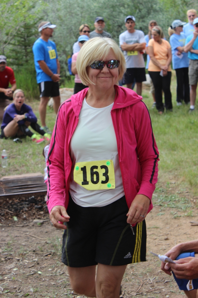 Photo of an age group winner receiving her award for the Tower Rock Run 5k