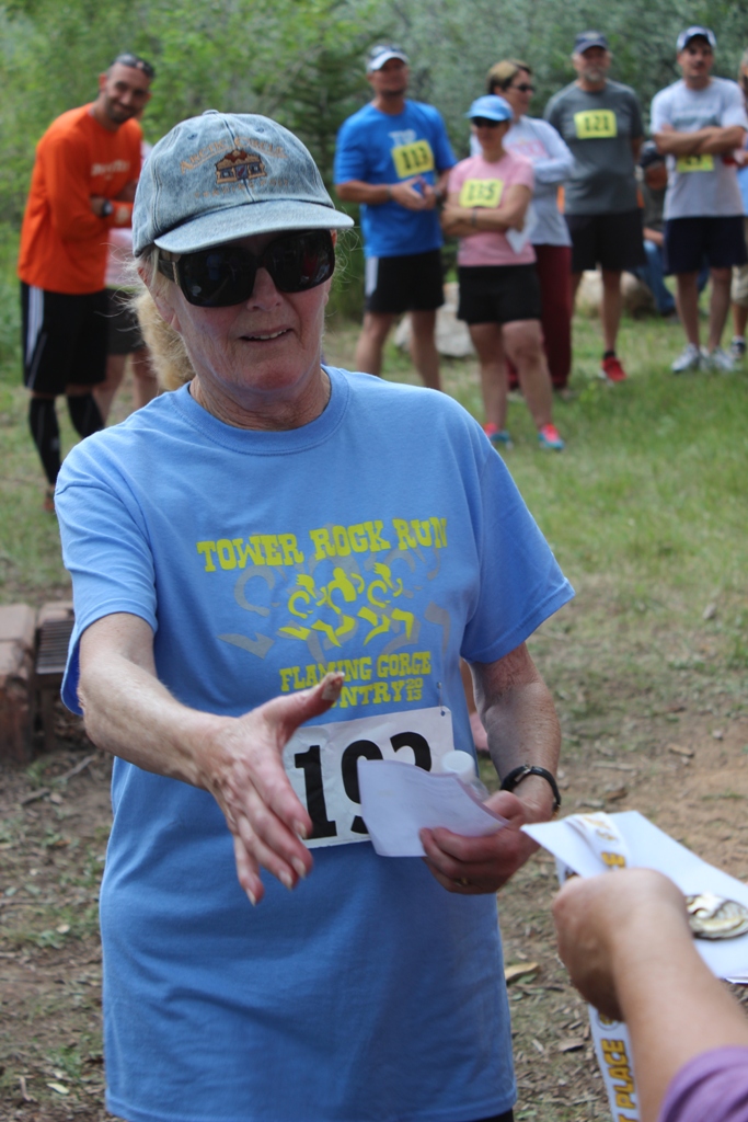 Photo of an age group winner receiving her award for the Tower Rock Run 5k