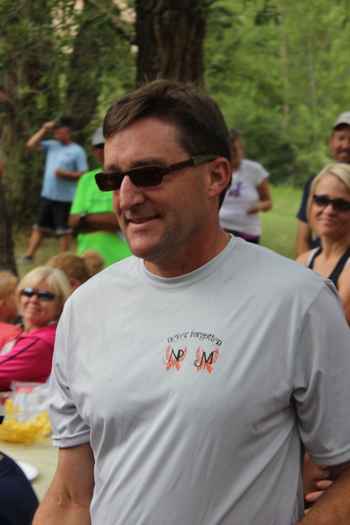 Photo of an age group winner receiving his award for the Tower Rock Run 5k