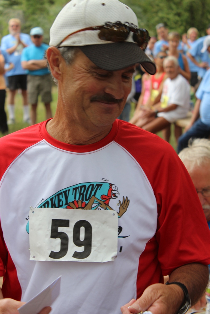 Photo of an age group winner receiving his award for the Tower Rock Run 5k