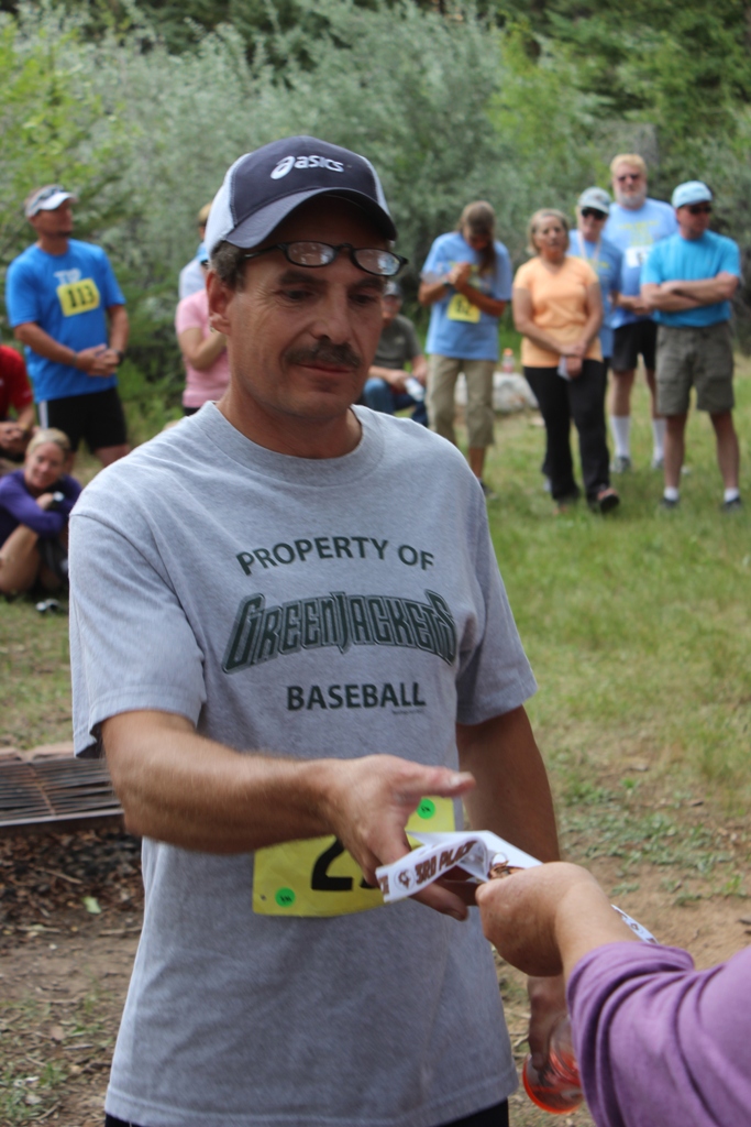 Photo of an age group winner receiving his award for the Tower Rock Run 5k