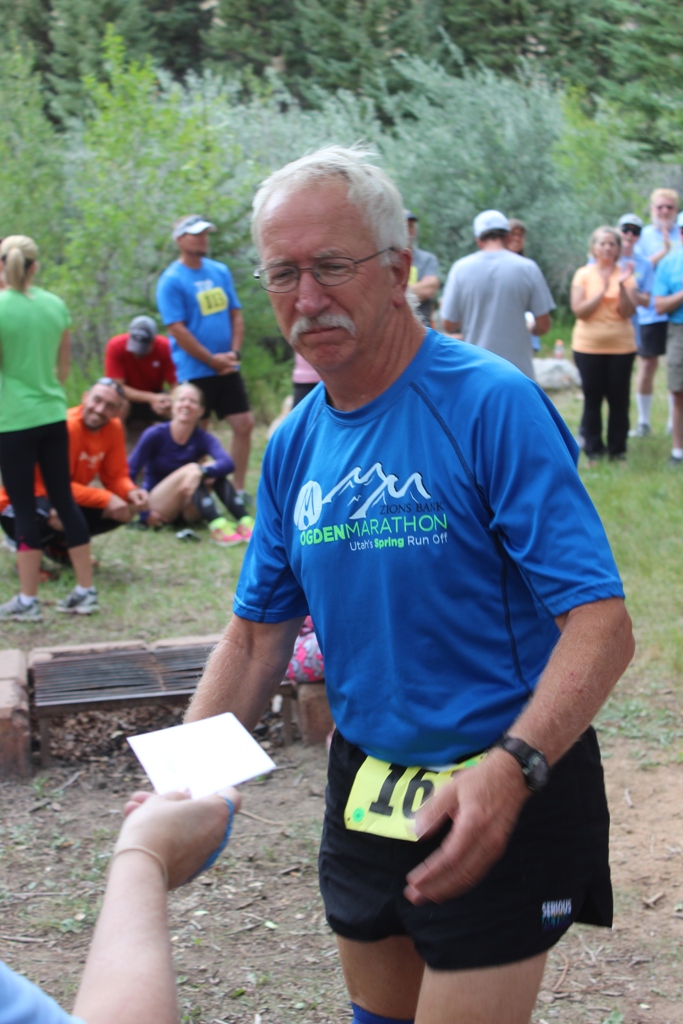 Photo of an age group winner receiving his award for the Tower Rock Run 5k