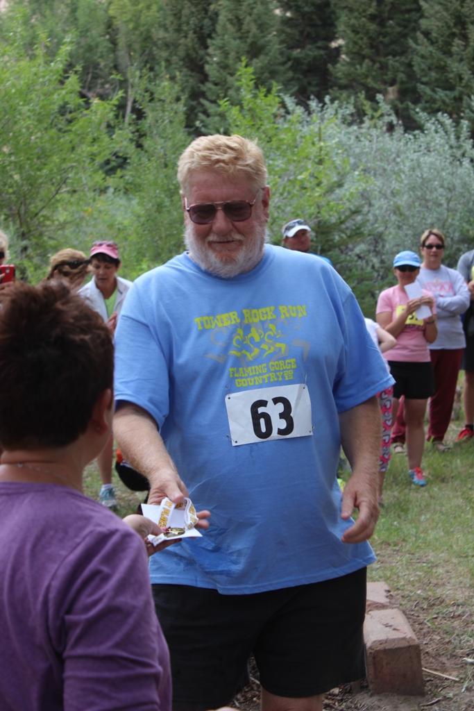 Photo of an age group winner receiving his award for the Tower Rock Run 5k