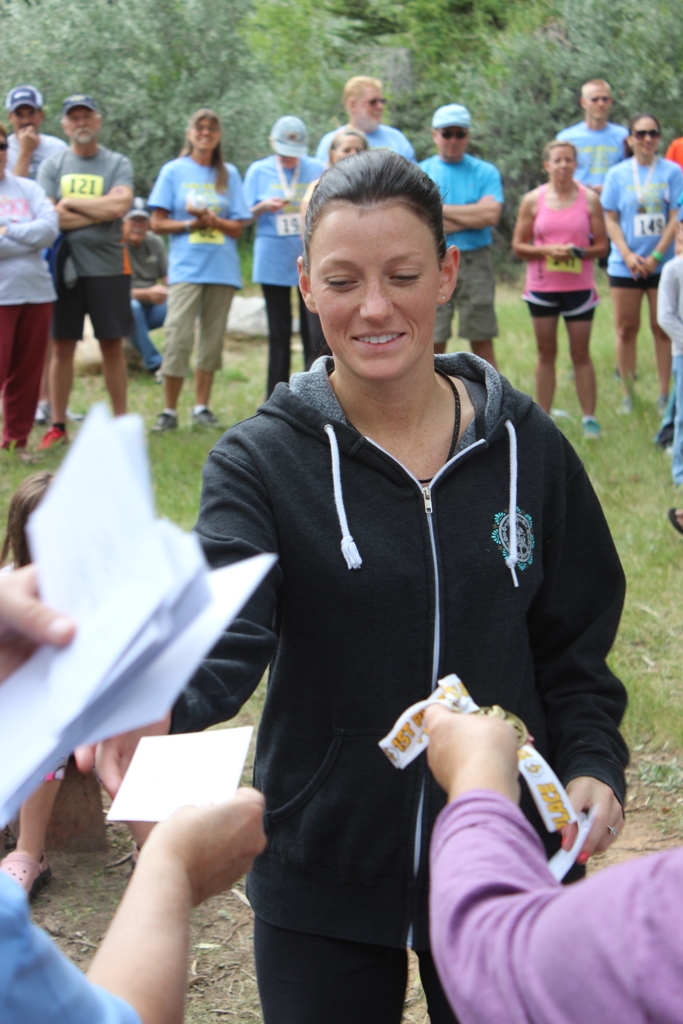 Photo of an age group winner receiving her award for the Tower Rock Run 10k