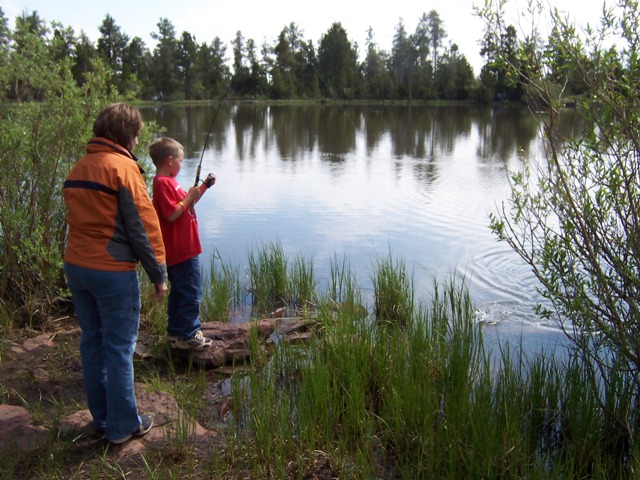 Photo of a child reeling in a fish at the Moose Ponds during the 2006 Kids Fishing Derby