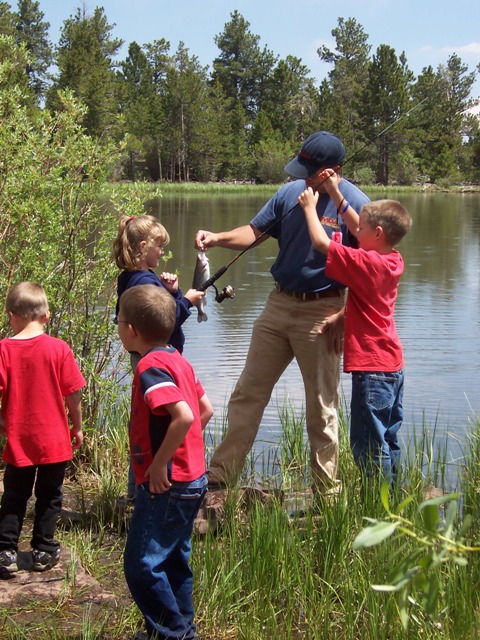 Photo of a girl grimacing at fish she caught at the Moose Ponds during the 2006 Kid's Fishing Derby